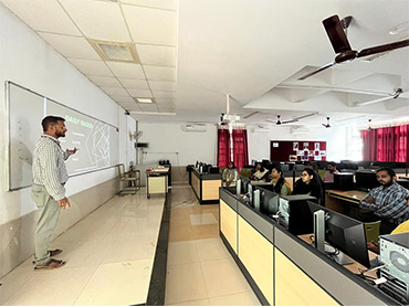 Two men in bicycle jerseys sitting outside at table having coffee